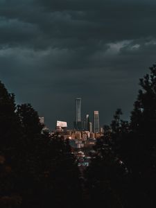 Preview wallpaper city, buildings, trees, clouds, dark
