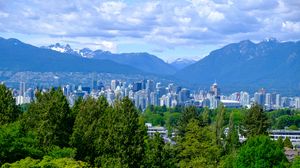 Preview wallpaper city, buildings, trees, mountains