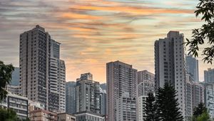 Preview wallpaper city, buildings, trees, sunset
