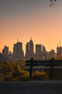 Preview wallpaper city, buildings, trees, bench, twilight