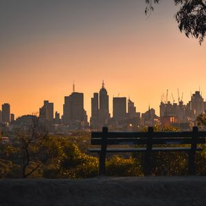 Preview wallpaper city, buildings, trees, bench, twilight