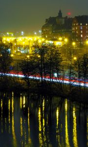 Preview wallpaper city, buildings, trees, light, twilight