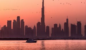 Preview wallpaper city, buildings, water, boat, birds, sunset