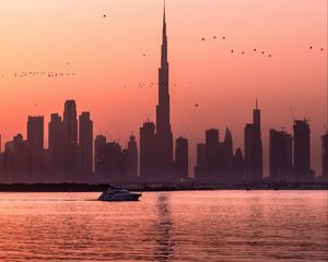 Preview wallpaper city, buildings, water, boat, birds, sunset