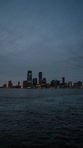 Preview wallpaper city, buildings, water, lights, twilight