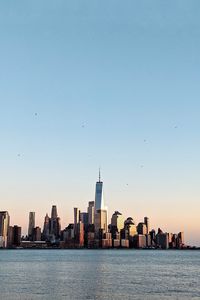 Preview wallpaper city, buildings, water, birds