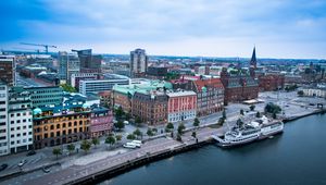 Preview wallpaper city, buildings, water, boat, aerial view