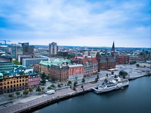 Preview wallpaper city, buildings, water, boat, aerial view