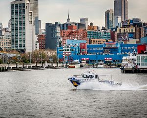 Preview wallpaper city, buildings, water, boat, pier