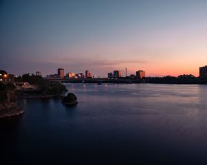 Preview wallpaper city, buildings, water, twilight, sunset