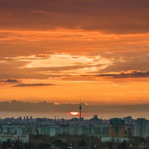 Preview wallpaper city, cityscape, buildings, sun, sunset