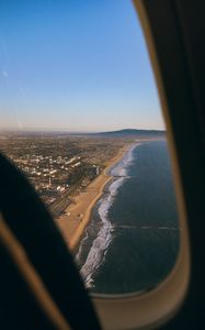Preview wallpaper city, coast, aerial view, porthole, airplane