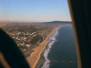 Preview wallpaper city, coast, aerial view, porthole, airplane