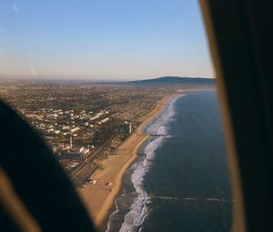 Preview wallpaper city, coast, aerial view, porthole, airplane