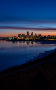 Preview wallpaper city, coast, buildings, water, reflection, night
