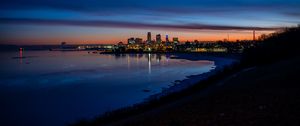 Preview wallpaper city, coast, buildings, water, reflection, night