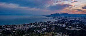 Preview wallpaper city, coast, sea, stones, evening