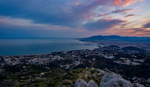 Preview wallpaper city, coast, sea, stones, evening