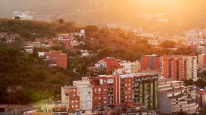 Preview wallpaper city, dawn, aerial view, sunlight, buildings