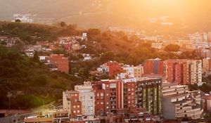 Preview wallpaper city, dawn, aerial view, sunlight, buildings