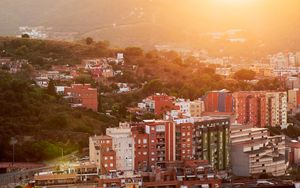 Preview wallpaper city, dawn, aerial view, sunlight, buildings
