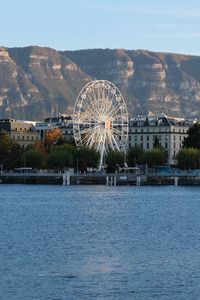 Preview wallpaper city, ferris wheel, coast, mountain, buildings