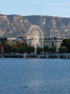 Preview wallpaper city, ferris wheel, coast, mountain, buildings