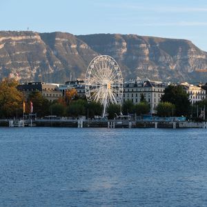 Preview wallpaper city, ferris wheel, coast, mountain, buildings