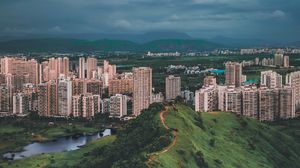 Preview wallpaper city, hill, grass, buildings, architecture