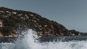 Preview wallpaper city, hill, sea, spray, rocks