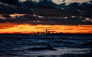 Preview wallpaper city, horizon, sunset, sea, waves