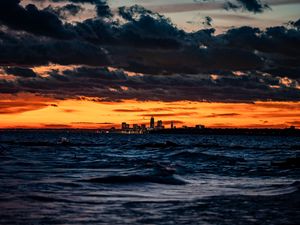 Preview wallpaper city, horizon, sunset, sea, waves