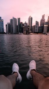 Preview wallpaper city, lake, legs, buildings, coast