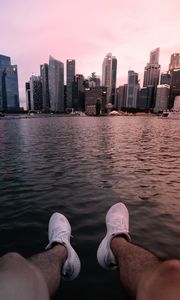 Preview wallpaper city, lake, legs, buildings, coast