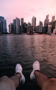 Preview wallpaper city, lake, legs, buildings, coast