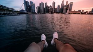 Preview wallpaper city, lake, legs, buildings, coast