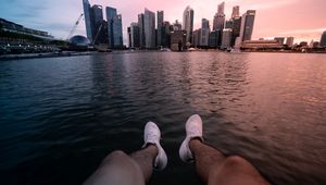 Preview wallpaper city, lake, legs, buildings, coast