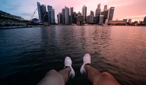Preview wallpaper city, lake, legs, buildings, coast
