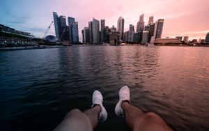 Preview wallpaper city, lake, legs, buildings, coast