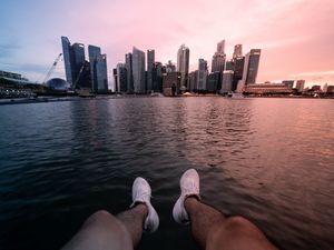 Preview wallpaper city, lake, legs, buildings, coast
