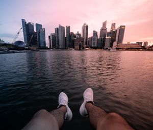 Preview wallpaper city, lake, legs, buildings, coast