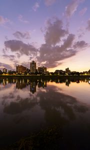 Preview wallpaper city, lake, shore, buildings, water, reflection