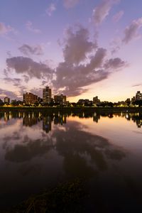 Preview wallpaper city, lake, shore, buildings, water, reflection
