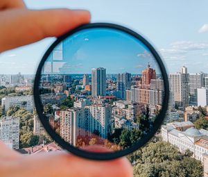 Preview wallpaper city, lens, hand, buildings