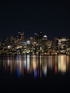 Preview wallpaper city, metropolis, buildings, coast, night, reflection