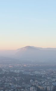 Preview wallpaper city, mountain, fog, sky, aerial view