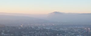 Preview wallpaper city, mountain, fog, sky, aerial view