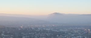 Preview wallpaper city, mountain, fog, sky, aerial view