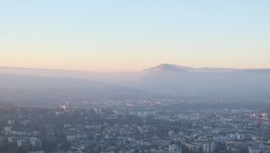 Preview wallpaper city, mountain, fog, sky, aerial view