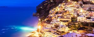 Preview wallpaper city, mountain, light, sea, twilight, evening